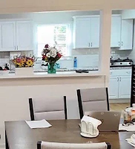 Home Fresh flowers on the counter between the dining room and kitchen