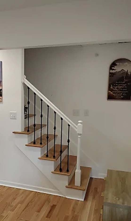 The common area and staircase at Epic Senior Care, with hardwood floors
